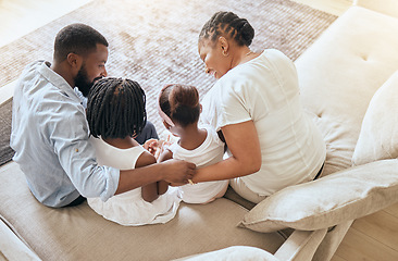 Image showing Black family, care and love while bonding on living room couch with children, mother and father together with trust and support. Man, woman and young kids sitting on sofa to relax from top view