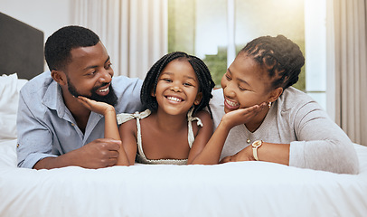 Image showing Black family, girl and smile on bed for portrait with mom, dad and happiness in bonding, care or embrace. Happy family, daughter or child together in bedroom with black woman, quality time and father