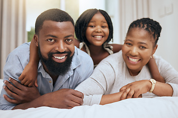 Image showing Black family, portrait or bonding on bed in house, home bedroom or hotel in trust, love or security for mothers day or fathers day. Smile, hug and happy girl, child or daughter with mother and father