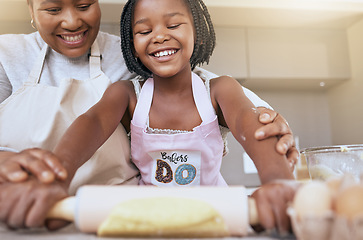 Image showing Baking, mother and child helping in the kitchen, learning and smile for rolling dough together in a house. Food, happy and African mom teaching a girl kid to bake or cooking in their family home
