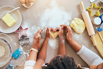 Image showing Black woman, child hands or kitchen baking of heart shape pastry, house cookies or dessert biscuit scone in family home. Top view, mother or girl cooking food in help, support or learning cake recipe