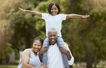 Image showing Portrait of a happy black family in nature to relax bonding in freedom, wellness and peace together in a park. Mother, father and child loves flying, hugging or playing outdoors enjoying quality time