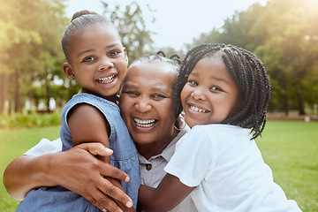 Image showing Park, black family and portrait of children with grandmother bonding, smiling and having fun. Summer, love and grandma embrace and hug girls for quality time on weekend, holiday and vacation outdoors