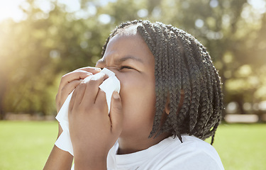 Image showing Covid, health and black kid blowing nose at park, nature or outdoors. Wellness, healthcare and sick girl child with tissue to wipe nose for virus, infection or cold, flu or covid 19, fever or allergy