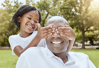 Image showing Park, surprise and girl with happy dad, hands over eyes and playing at picnic in garden. Nature, love and family, young child and black man on grass for family fun in summer, spending time together.