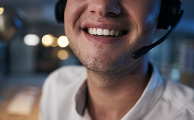Image showing Call center, smile and mouth of a worker in telemarketing, support and crm business in a dark office. Ecommerce, contact us and happy customer service agent with a headset during night shift