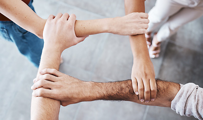 Image showing Hands, people and support with trust, teamwork and collaboration together for team goal from above. Group diversity in volunteer partnership, social solidarity or community of friends in circle arms