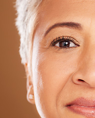 Image showing Skincare, eye and beauty of a senior woman on a studio background for cosmetics, makeup and dermatology product. Half face of a mature model with vision for clear, glow and healthy, looking skin