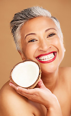 Image showing Senior woman, skincare and coconut in studio for beauty, health and wellness in happy cosmetic portrait. Healthy, elderly black woman and fruit by face for cosmetics, skin and happiness by background