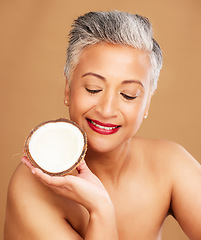 Image showing Beauty, coconut and skincare with woman in natural cosmetic product advertising against studio background. Healthy skin, fresh and clean with organic cosmetics, face and body care for antiaging.