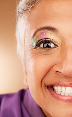 Image showing Eye, makeup and woman being creative, colorful and smile for fun, happy and content with brown studio background. Cosmetics, elderly female or senior lady with glitter for happiness or natural beauty