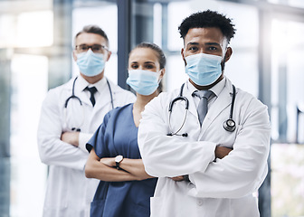 Image showing Face mask, team and portrait of medical doctors standing in the hallway or corridor of a hospital. Teamwork, collaboration and group of healthcare employees ready for a covid consultation in a clinic