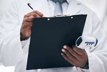 Image showing Covid, doctor with thermometer and clipboard writing on patient chart or medical insurance documents. Research, innovation in healthcare and black man with paperwork in hands for safety in hospital.