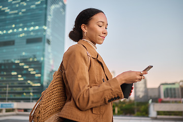 Image showing Black woman, smartphone and outdoor for communication, search internet and browse online. African American female, young lady and in city with cellphone for social media apps, chatting and connect.