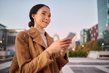 Image showing Phone, social media and city with a business black woman walking on a street or road on her evening commute. 5g mobile technology, communication and networking with a female employee in an urban town