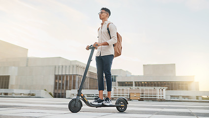 Image showing Man on scooter for travel, eco friendly transport and urban with environment and sustainability on commute to work. Young hipster, electric scooter and clean carbon footprint motivation in cityscape.