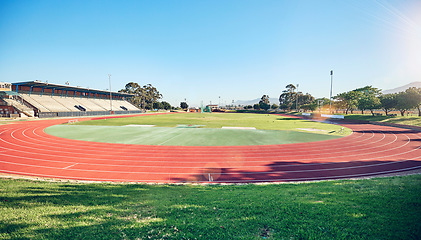 Image showing Empty running track, arena or stadium architecture for marathon race, sports cardio training or fitness workout. Blue sky, olympic course and event field for athletics contest, competition or games