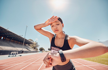 Image showing Woman, tired or smart watch check on running track fitness, workout or training for sprint marathon, training challenge or race event. Stress, sweating or exhausted sports runner with speed time tech