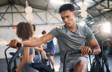 Image showing Gym, fitness and man on a spinning bike for exercise, health and cross training, power and motivation. energy, spinning bike and black man on air bike and sports center for wellness, workout and fit