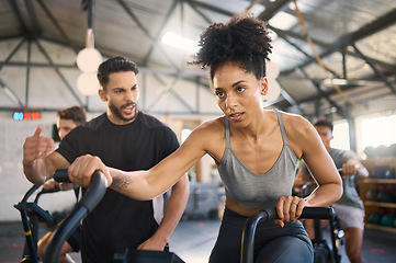 Image showing Exercise bike, motivation and personal trainer with a black woman in gym for exercise or fitness. Wellness, training and cycling with a female and coach working together in a health or wellness club