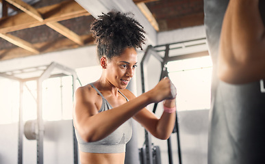 Image showing Fitness, black woman and boxing for training, exercise or healthy workout for strength or endurance at the gym. African American female boxer in sports activity hitting punching bag for self defense