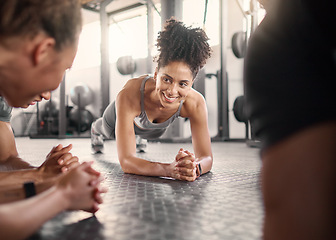 Image showing Happy black woman, group and plank in gym for health, fitness and wellness with strong core on floor. Friends workout, abdominal exercise and training collaboration with smile, support and diversity