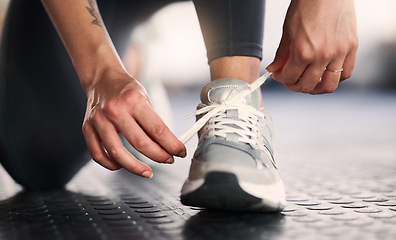 Image showing Woman, hands and shoelace tie for gym workout, training or exercise in wellness, health or fitness club. Zoom, personal trainer and coach legs with sports shoes, body goals and challenge motivation