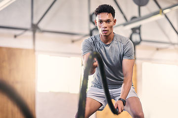 Image showing Gym battle ropes, training and black man athlete in a cardio, workout and sports exercise. Man in a wellness rope and health club with power, energy and strong muscle doing fitness and trainer lift