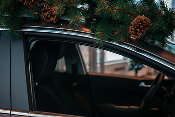 Image showing Car with christmas tree on roof