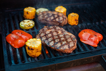 Image showing Pork meat steaks on the grill