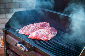 Image showing Pork meat steaks on the grill