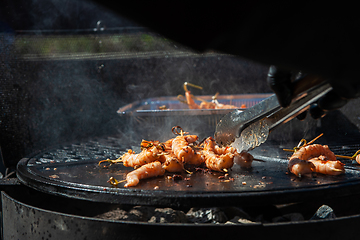 Image showing A professional cook prepares shrimps