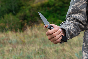 Image showing A man with a knife in the forest.