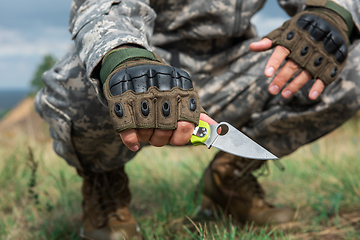 Image showing A man with a knife in the forest.