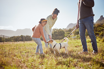 Image showing Dog, park and pet family with child, mother and father in nature or a grass field for outdoor wellness. Bonding, love and care of animal or puppy with parents or mom and dad with girl by countryside