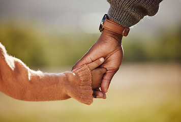 Image showing Family, holding hands and girl with father closeup in a park, hands and walking in nature, bond and relax outdoors. Love, trust and parent hands with child in support of trust, peace and unity