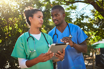 Image showing Doctor, team and tablet in healthcare discussion for medical prescription, consultation or procedure at a park. Doctors or veterinarian workers in conversation with touchscreen for research outdoors