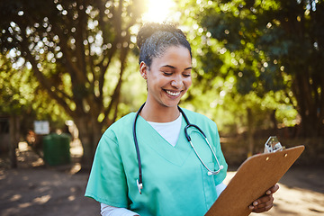 Image showing Woman, nurse and smile looking at clipboard in healthcare, medical or prescription in outdoor park. Happy female doctor or veterinary in nursing examination report, check or inspection for diagnosis