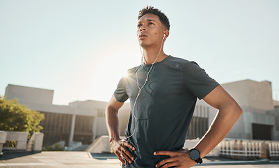 Image showing Music headphones, sunshine and fitness athlete ready for cardio exercise, marathon training or performance workout. Runner determination, blue sky flare and black man listening to radio or podcast