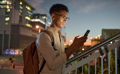 Image showing Man, city night and phone text of a student on social media app, internet or web search. Black man with mobile technology in the dark online reading and texting with a 5g connection outdoor