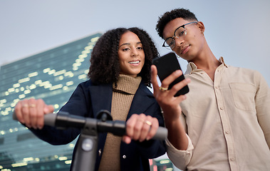 Image showing Scooter, woman and man with a phone on social media in a city networking or sharing online content. Electric scooter, smile or happy urban friends enjoy reading trending or viral global news at night