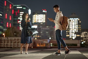 Image showing Business people, phone and city at night, social media and order transport with online app in New york. Man and woman workers leaving urban town late after work day with 5g mobile smartphone on web