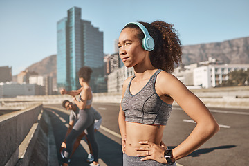 Image showing Music, fitness and black woman in city for running, exercise and sports, training and with friends outdoor. Podcast, runner and girl relax at workout on highway, listen to wellness, audio and mindset