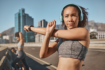 Image showing Fitness, city and people stretching with headphone music, podcast or streaming in Canada. Exercise, friends and black people getting ready for urban run workout together with arm stretch.