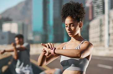 Image showing Fitness, black woman and sports watch to check progress, heart health and cardio running time while outdoor in city for health and wellness. African athlete with smartwatch for exercise and workout