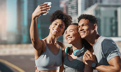 Image showing Phone, selfie and fitness with a man and woman sports group taking a photograph together in the city. Health, teamwork and mobile with an athlete group posing for a picture in an urban town