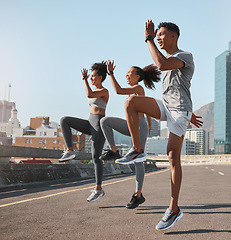 Image showing Exercise, friends and jump training in city for health, wellness and fitness. Sports, people and teamwork of runner group in street exercising, workout and jumping practice outdoors on urban road.