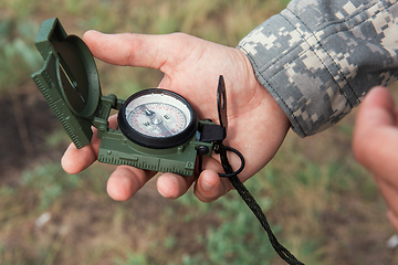 Image showing Man with compass in hand outdoor