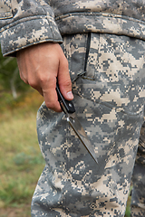 Image showing A man with a knife in the forest.