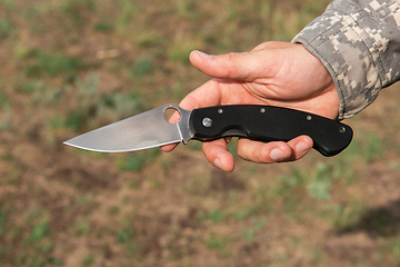 Image showing A man with a knife in the forest.